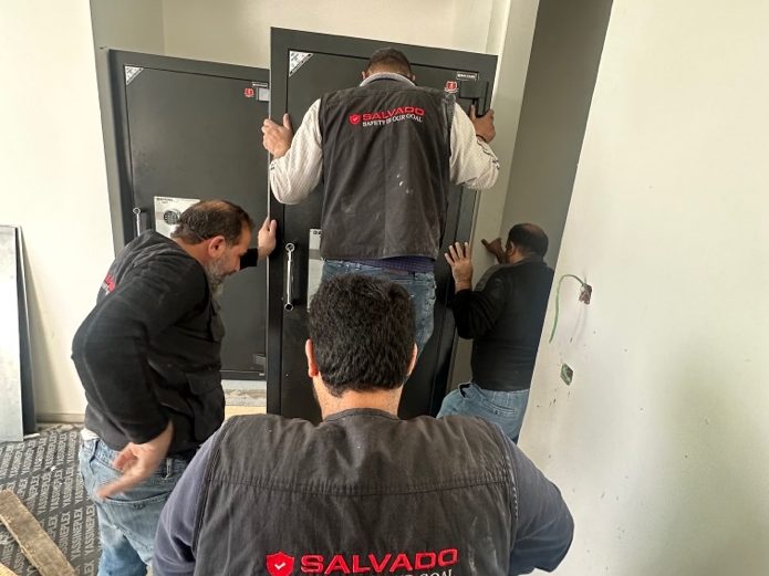 Salvado team installing a safe into a built-in wall recess